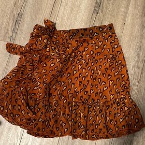 Orange urban outfitters skirt with small hearts and bow on the side